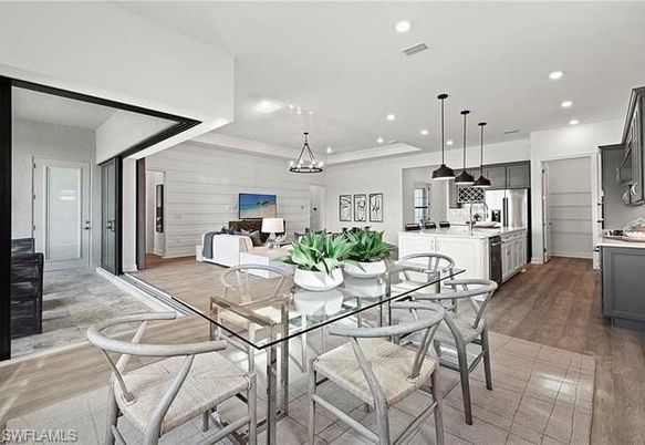 Chandelier, Dining room, Interior, Kitchen, Living room, Pendant Lights, Recessed Lighting, Stainless Steel Appliances, Wood Texture Flooring