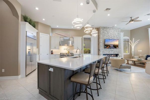 Fireplace, Interior, Kitchen, Living room, Pendant Lights, Recessed Lighting, Stainless Steel Appliances, Stone Walls