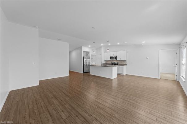 Empty room, Interior, Kitchen, Pendant Lights, Recessed Lighting, Stainless Steel Appliances, Wood Texture Flooring