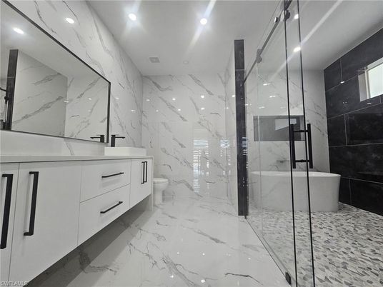 Bathroom, Dual Sink Vanities, Free Standing Baths, Glass Shower, Interior, Marble, Marble Walls, Recessed Lighting