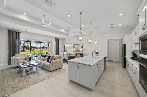 Chandelier, Dining room, Interior, Kitchen, Living room, Pendant Lights, Recessed Lighting, Stainless Steel Appliances, Wood Texture Flooring