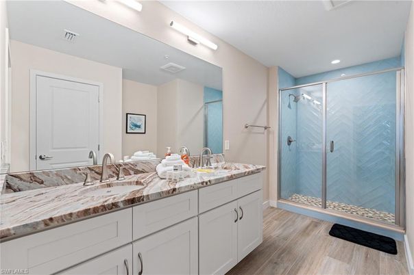Bathroom, Dual Sink Vanities, Glass Shower, Interior, Recessed Lighting, Wood Texture Flooring