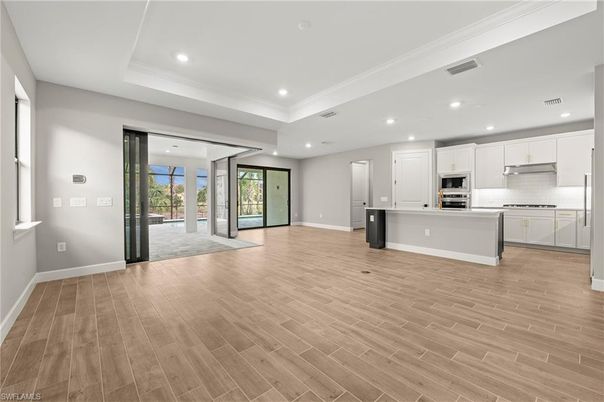 Empty room, Interior, Kitchen, Recessed Lighting, Stainless Steel Appliances, Wood Texture Flooring