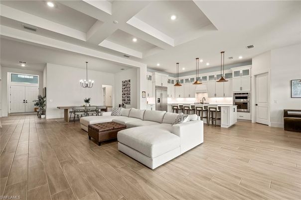 Chandelier, Dining room, Interior, Kitchen, Living room, Pendant Lights, Recessed Lighting, Stainless Steel Appliances, Wood Texture Flooring