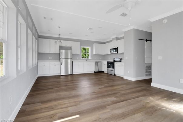 Empty room, Interior, Kitchen, Pendant Lights, Recessed Lighting, Stainless Steel Appliances, Wood Texture Flooring