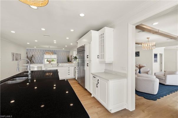 Chandelier, Interior, Kitchen, Living room, Pendant Lights, Recessed Lighting, Stainless Steel Appliances, Wood Texture Flooring