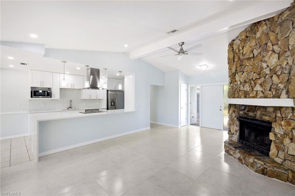 Fireplace, Interior, Kitchen, Pendant Lights, Recessed Lighting, Stainless Steel Appliances, Stone Walls