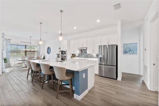 Dining room, Interior, Kitchen, Pendant Lights, Recessed Lighting, Stainless Steel Appliances, Wood Texture Flooring
