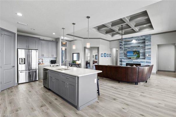 Fireplace, Interior, Kitchen, Living room, Pendant Lights, Recessed Lighting, Stainless Steel Appliances, Stone Walls, Wood Texture Flooring