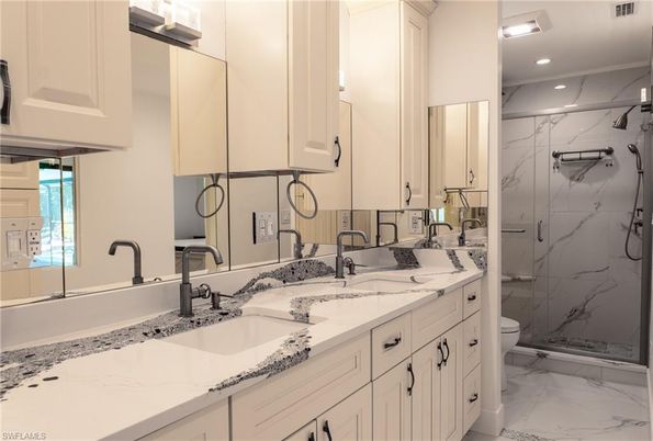 Bathroom, Dual Sink Vanities, Glass Shower, Interior, Marble, Marble Walls, Recessed Lighting