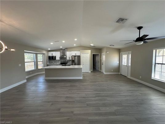 Empty room, Interior, Kitchen, Pendant Lights, Recessed Lighting, Stainless Steel Appliances, Wood Texture Flooring
