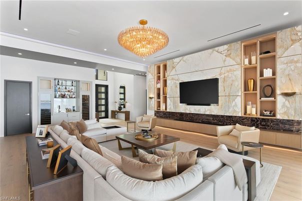 Chandelier, Fireplace, Interior, Living room, Marble Walls, Recessed Lighting, Wood Texture Flooring