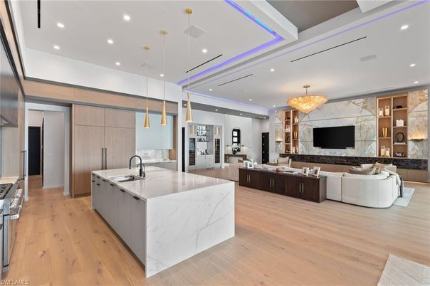 Chandelier, Fireplace, Interior, Kitchen, Living room, Marble Walls, Pendant Lights, Recessed Lighting, Wood Texture Flooring