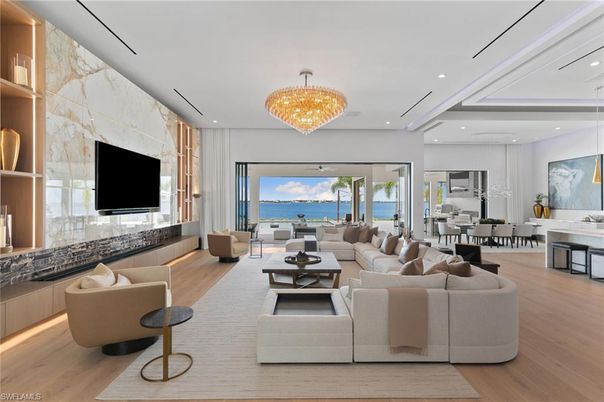 Chandelier, Dining room, Fireplace, Interior, Living room, Marble Walls, Recessed Lighting, Water, Wood Texture Flooring