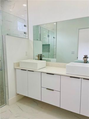 Bathroom, Dual Sink Vanities, Glass Shower, Interior, Marble, Marble Walls, Recessed Lighting