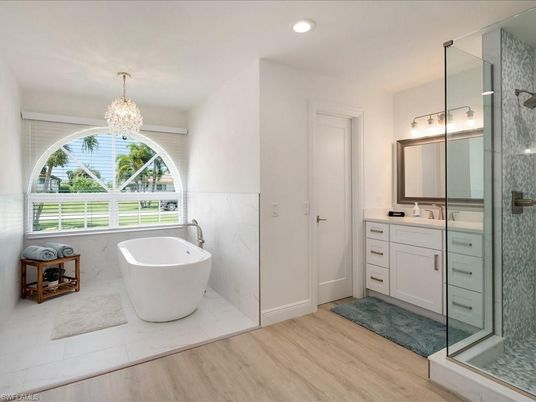 Bathroom, Chandelier, Free Standing Baths, Glass Shower, Interior, Recessed Lighting, Wood Texture Flooring