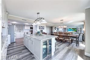 Chandelier, Dining room, Interior, Kitchen, Pendant Lights, Stainless Steel Appliances, Wood Texture Flooring