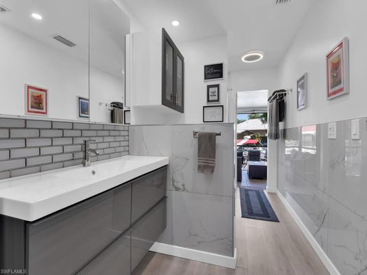 Bathroom, Glass Shower, Interior, Marble Walls, Recessed Lighting, Wood Texture Flooring