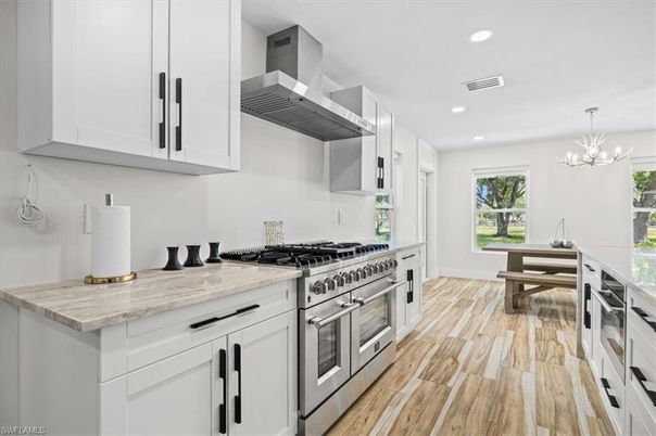 Chandelier, Dining room, Interior, Kitchen, Pendant Lights, Recessed Lighting, Stainless Steel Appliances, Wood Texture Flooring