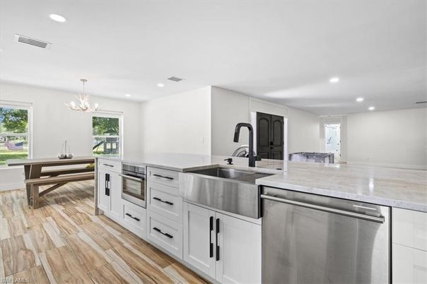 Chandelier, Interior, Kitchen, Pendant Lights, Recessed Lighting, Stainless Steel Appliances, Wood Texture Flooring