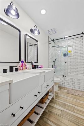 Bathroom, Dual Sink Vanities, Glass Shower, Interior, Recessed Lighting, Wood Texture Flooring