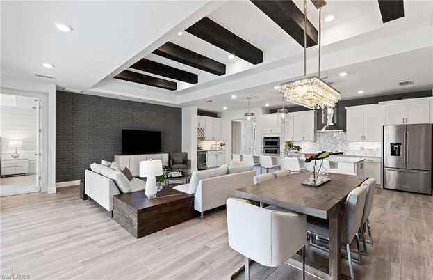 Chandelier, Dining room, Interior, Kitchen, Living room, Pendant Lights, Recessed Lighting, Stainless Steel Appliances, Stone Walls, Wooden Beams, Wood Texture Flooring