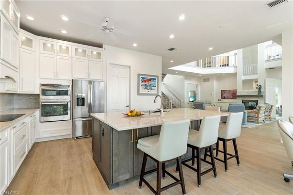 Dining room, Fireplace, Interior, Kitchen, Recessed Lighting, Stainless Steel Appliances, Wood Texture Flooring