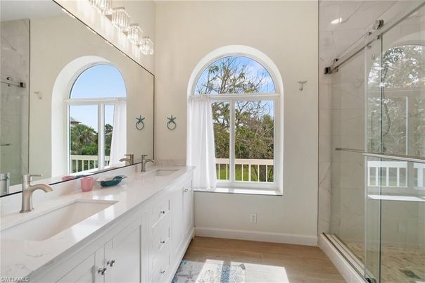 Bathroom, Dual Sink Vanities, Glass Shower, Interior, Marble Walls, Wood Texture Flooring