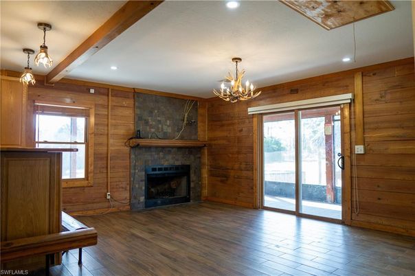 Chandelier, Empty room, Fireplace, Interior, Pendant Lights, Recessed Lighting, Wooden Beams, Wood Texture Flooring, Wooden Walls