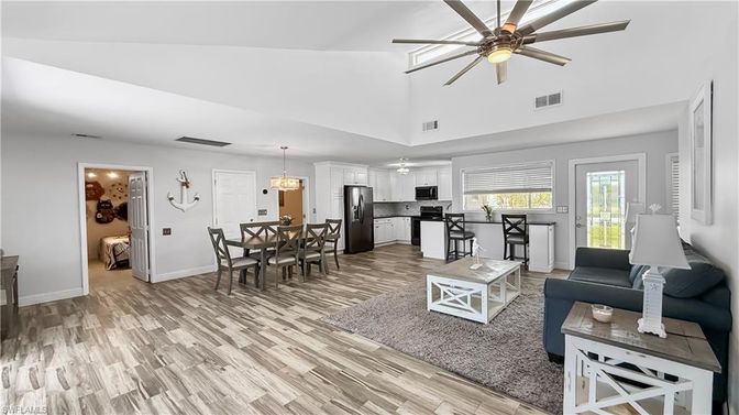 Chandelier, Dining room, Interior, Kitchen, Living room, Pendant Lights, Stainless Steel Appliances, Wood Texture Flooring