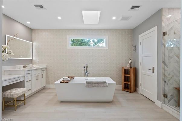 Bathroom, Dual Sink Vanities, Free Standing Baths, Interior, Marble Walls, Recessed Lighting, Wood Texture Flooring