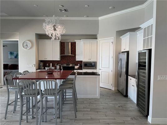Chandelier, Dining room, Interior, Kitchen, Pendant Lights, Recessed Lighting, Stainless Steel Appliances, Wood Texture Flooring