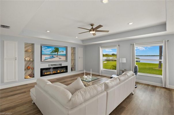Fireplace, Interior, Living room, Recessed Lighting, Water, Wood Texture Flooring