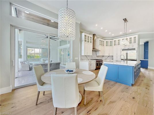 Chandelier, Dining room, Interior, Kitchen, Pendant Lights, Recessed Lighting, Stainless Steel Appliances, Wood Texture Flooring