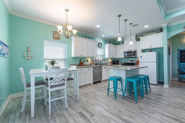 Chandelier, Dining room, Interior, Kitchen, Pendant Lights, Recessed Lighting, Stainless Steel Appliances, Wood Texture Flooring