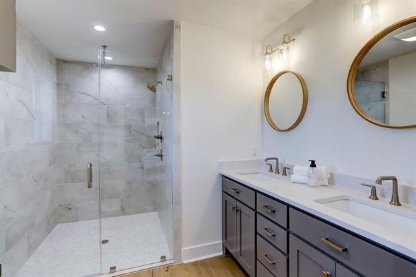 Bathroom, Dual Sink Vanities, Glass Shower, Interior, Marble Walls, Recessed Lighting, Wood Texture Flooring