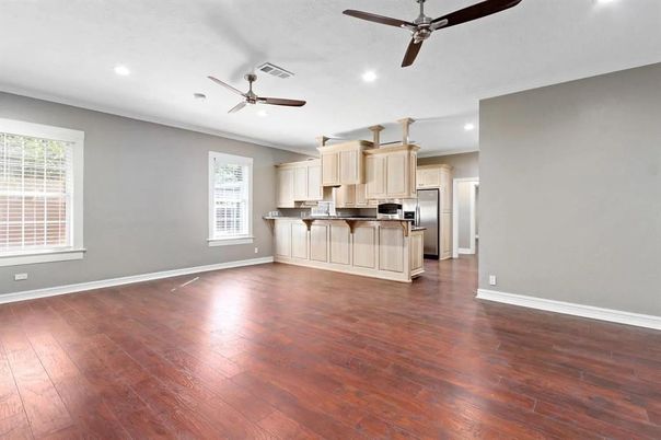 Empty room, Interior, Kitchen, Recessed Lighting, Stainless Steel Appliances, Wood Texture Flooring
