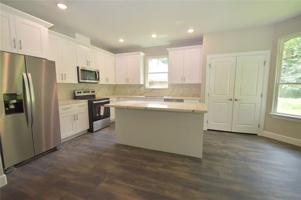 Interior, Kitchen, Marble Walls, Recessed Lighting, Stainless Steel Appliances, Wood Texture Flooring