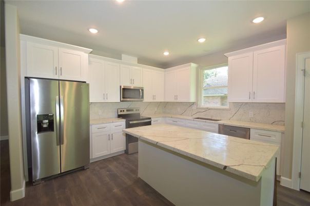 Interior, Kitchen, Marble Walls, Recessed Lighting, Stainless Steel Appliances, Wood Texture Flooring