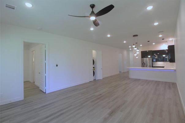 Empty room, Interior, Kitchen, Pendant Lights, Recessed Lighting, Stainless Steel Appliances, Wood Texture Flooring