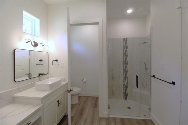Bathroom, Dual Sink Vanities, Glass Shower, Interior, Recessed Lighting, Wood Texture Flooring