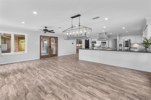 Chandelier, Empty room, Interior, Kitchen, Pendant Lights, Recessed Lighting, Stainless Steel Appliances, Wood Texture Flooring