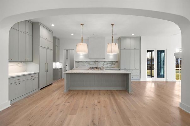 Interior, Kitchen, Marble Walls, Pendant Lights, Recessed Lighting, Stainless Steel Appliances, Wood Texture Flooring