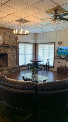Chandelier, Dining room, Fireplace, Interior, Living room, Stone Walls, Wood Texture Flooring