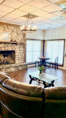 Chandelier, Dining room, Fireplace, Interior, Living room, Stone Walls, Wood Texture Flooring