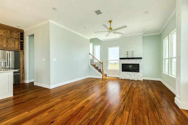 Empty room, Fireplace, Interior, Kitchen, Stainless Steel Appliances, Wood Texture Flooring