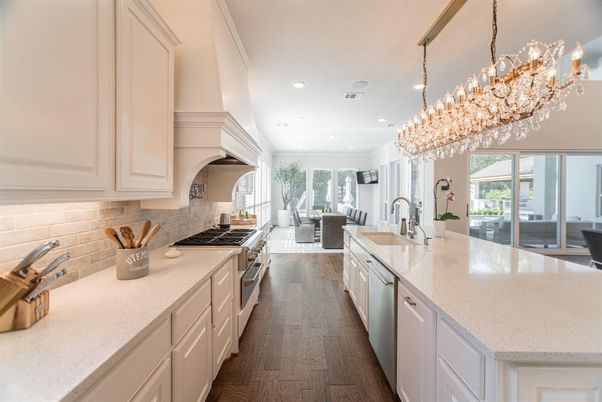 Chandelier, Dining room, Interior, Kitchen, Living room, Pendant Lights, Recessed Lighting, Stainless Steel Appliances, Wood Texture Flooring