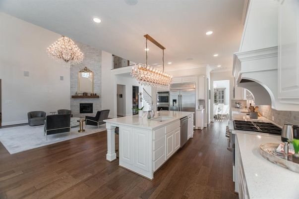 Chandelier, Fireplace, Interior, Kitchen, Living room, Recessed Lighting, Stainless Steel Appliances, Wood Texture Flooring