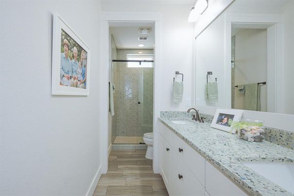 Bathroom, Dual Sink Vanities, Glass Shower, Interior, Recessed Lighting, Wood Texture Flooring