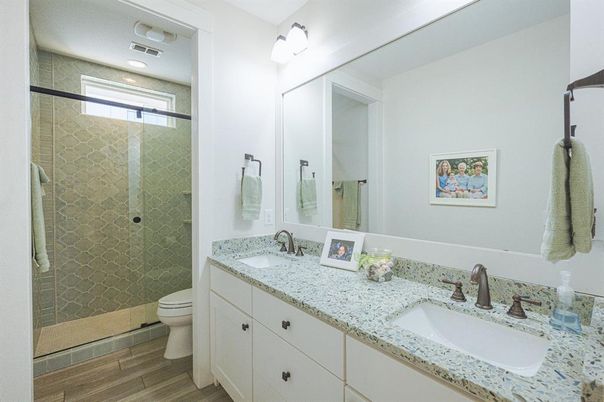 Bathroom, Dual Sink Vanities, Glass Shower, Interior, Recessed Lighting, Wood Texture Flooring